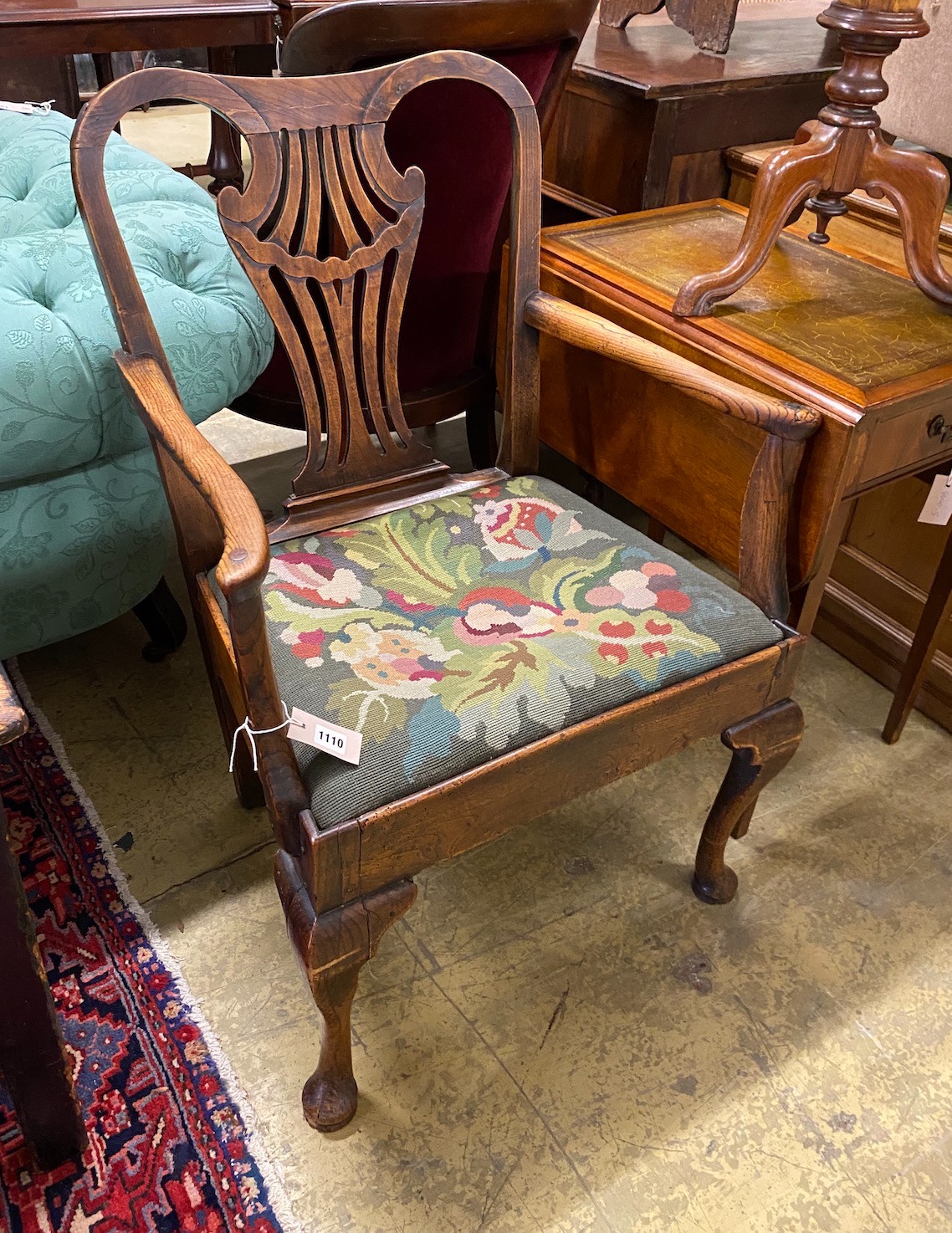 A George III provincial elm seat elbow chair with tapestry upholstered drop in seat, width 66cm, depth 47cm, height 94cm